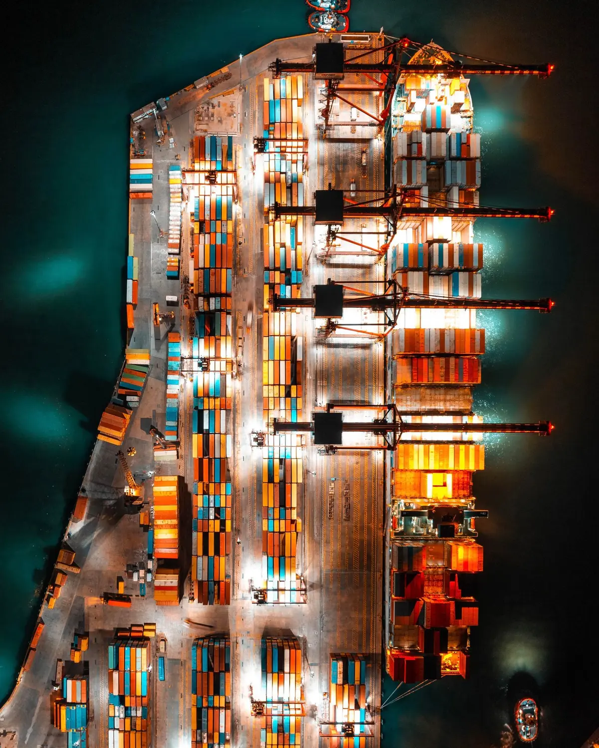 A container terminal and ship seen from above at night